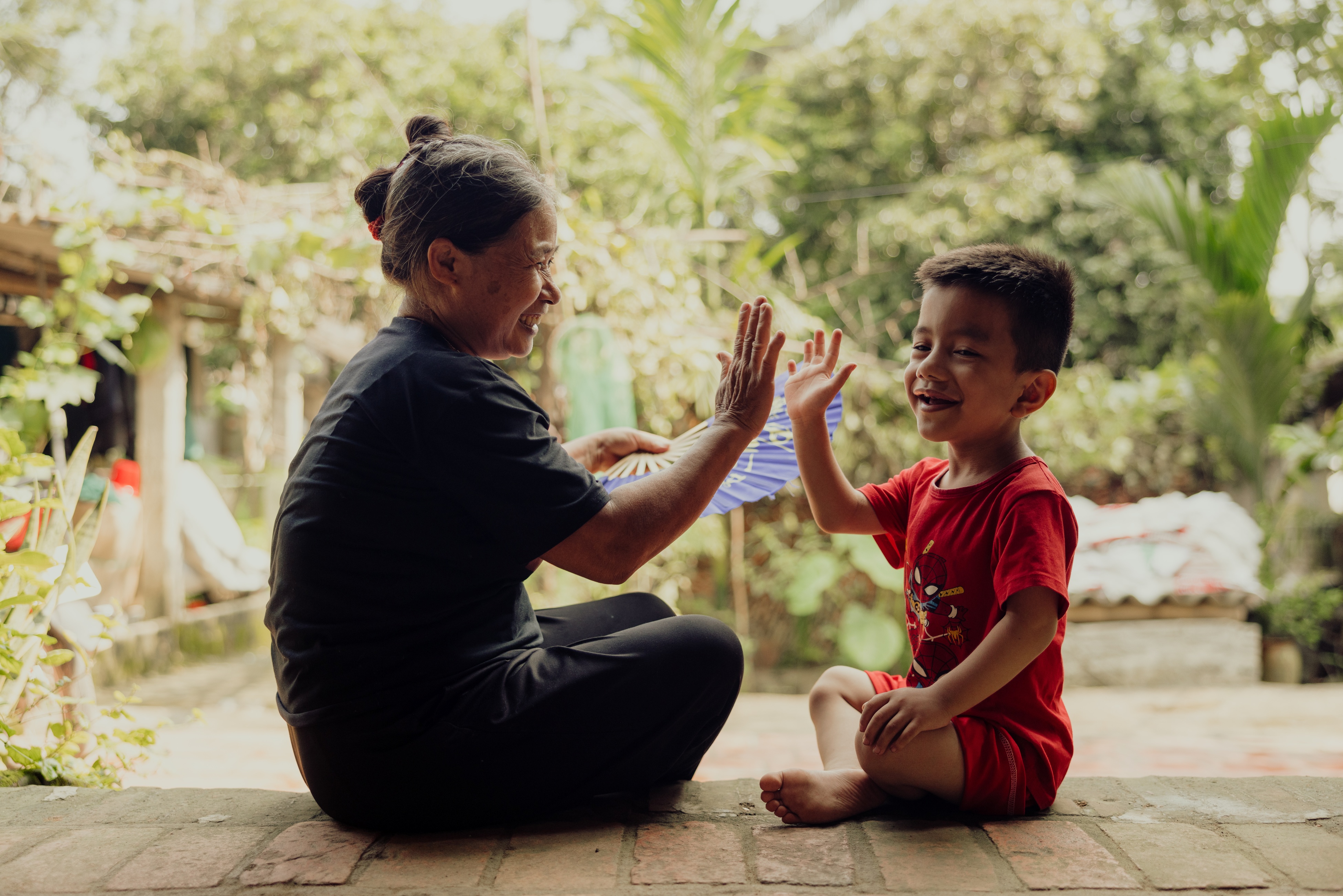 Hands holding a child sponsorship photo card