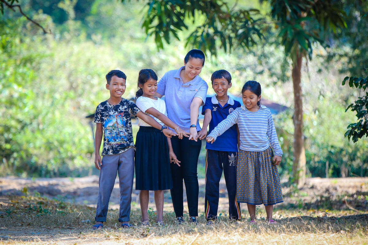 Hands holding a child sponsorship photo card