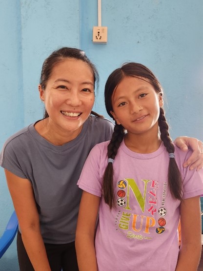 Kelly and her sponsored child in Nepal