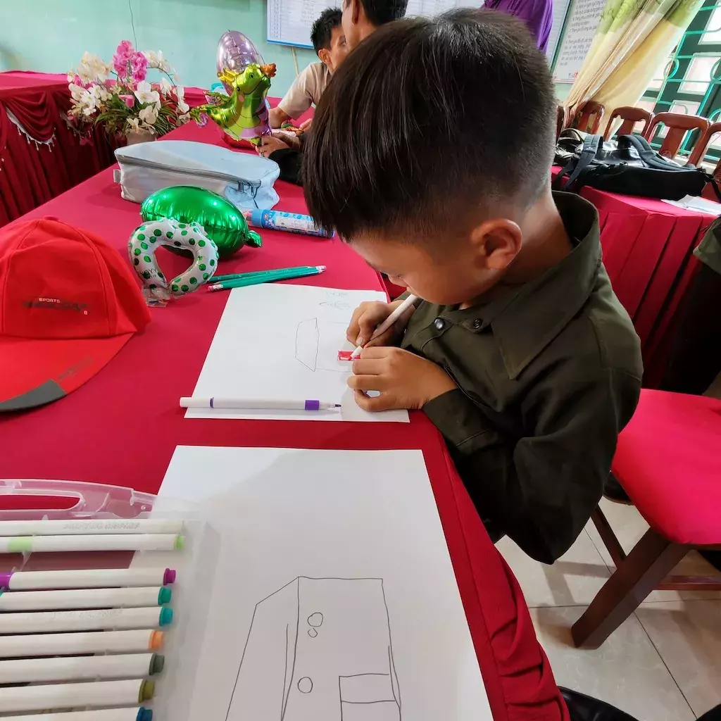 Adeline’s sponsored child, A Chan drawing his home.
