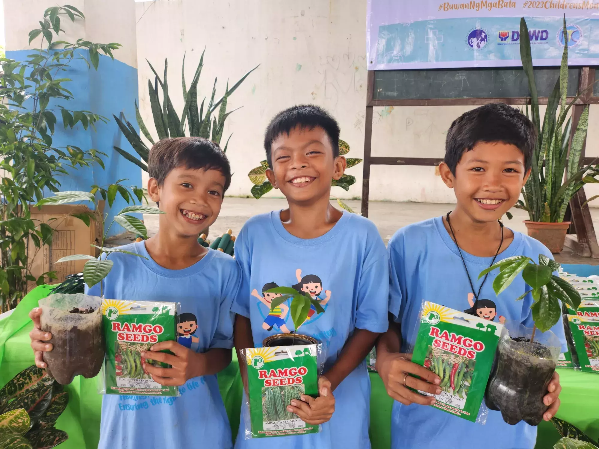 children holding plant seedlings in Antique Philippines