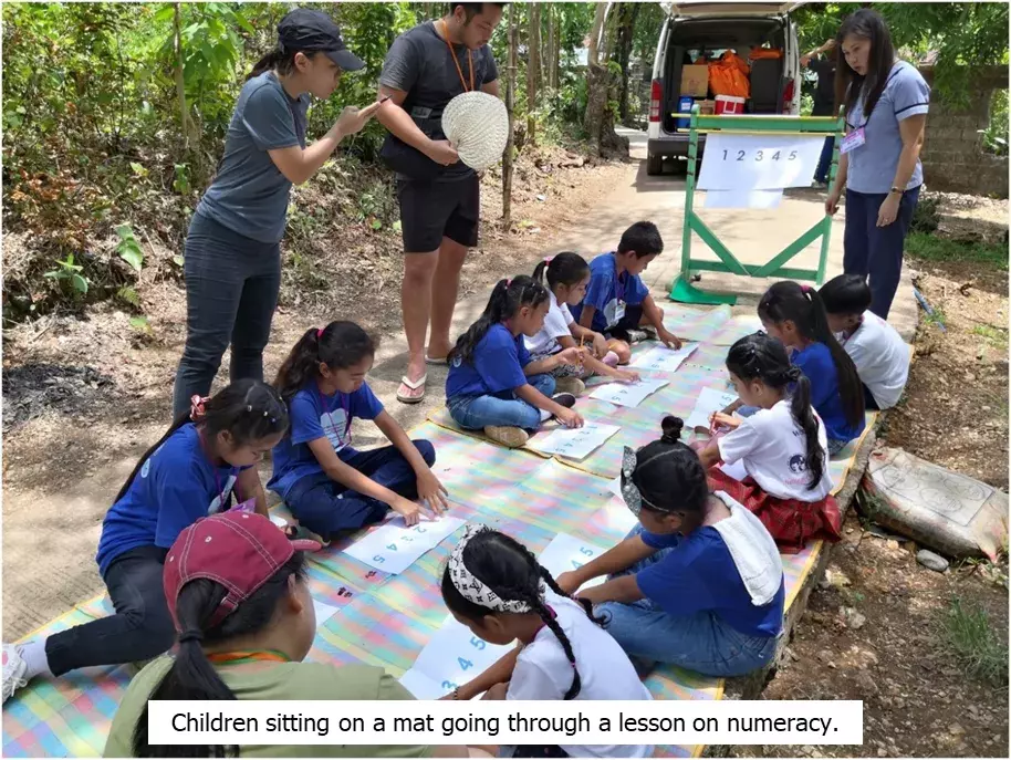 children_sitting_on_a_mat