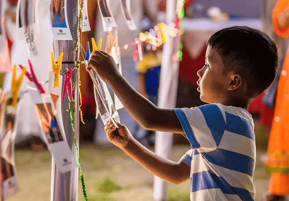 Child choosing photo during Chosen Choosing Party