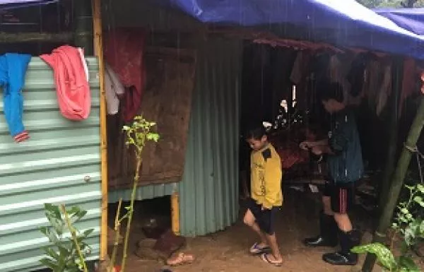 Boy in his home in Vietnam after Typhoon Yagi