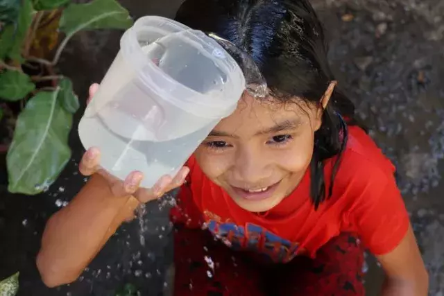 a girl with a cup of water