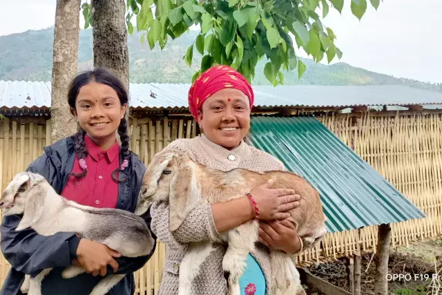  mother and child holding out goats for livelihood