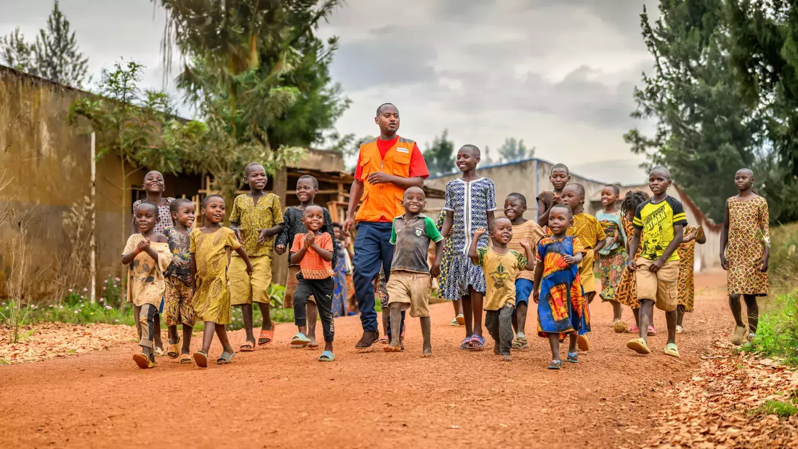 World Vision staff walking with children in Africa