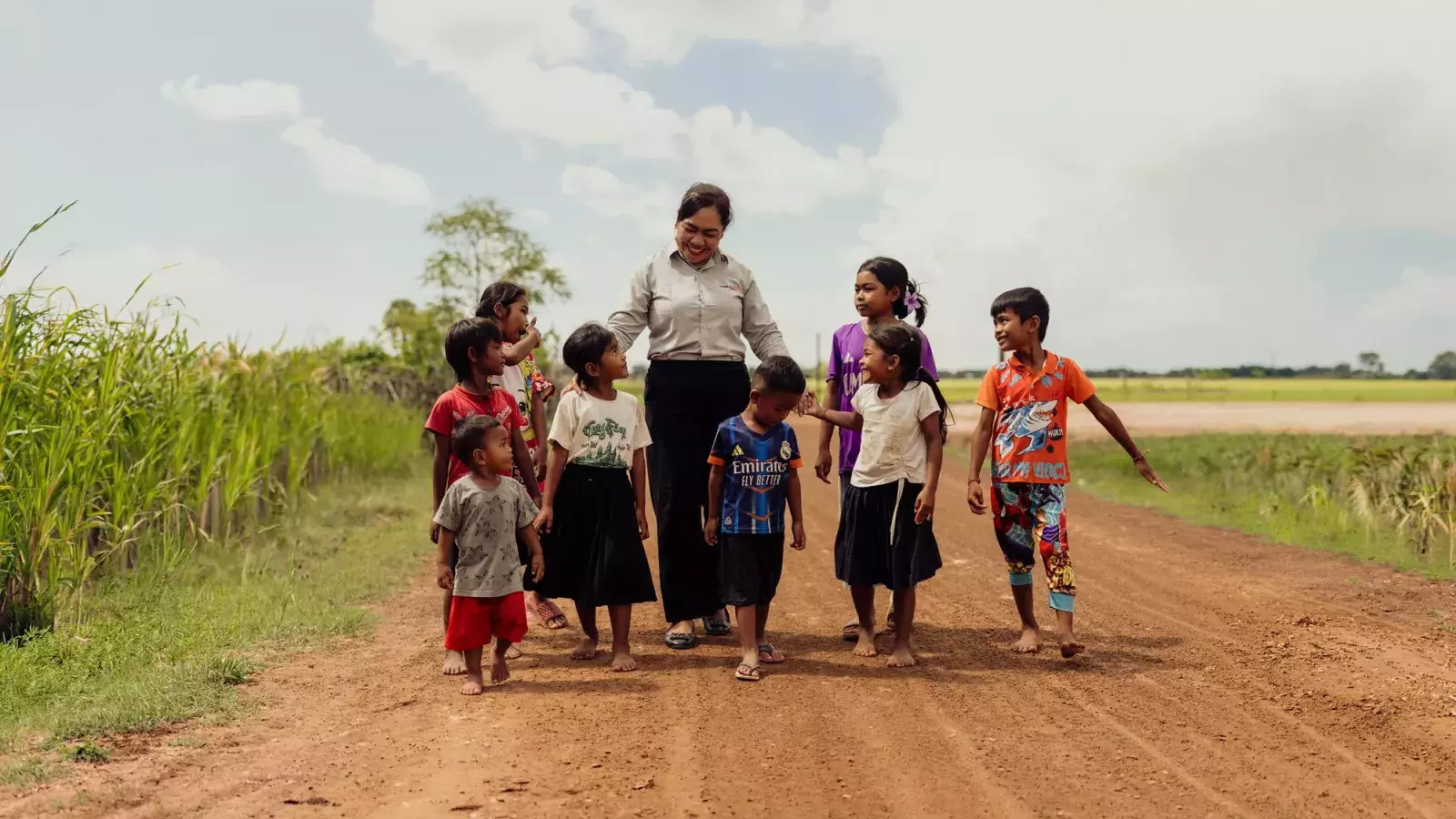 World Vision Cambodia Staff with the children in field
