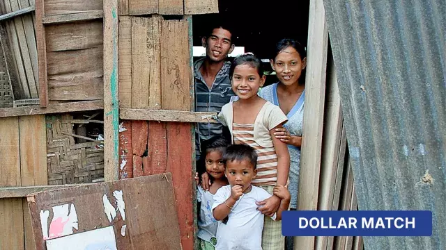 Smiling family of five at doorway with dollar match label